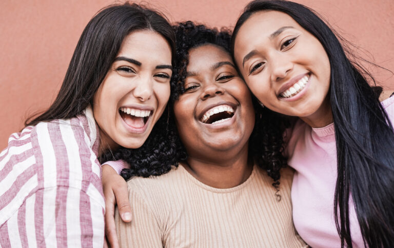 Happy latin women laughing and looking in camera - Millennial gi