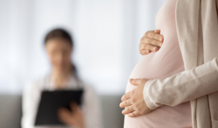 pregnant woman and blurred doctor